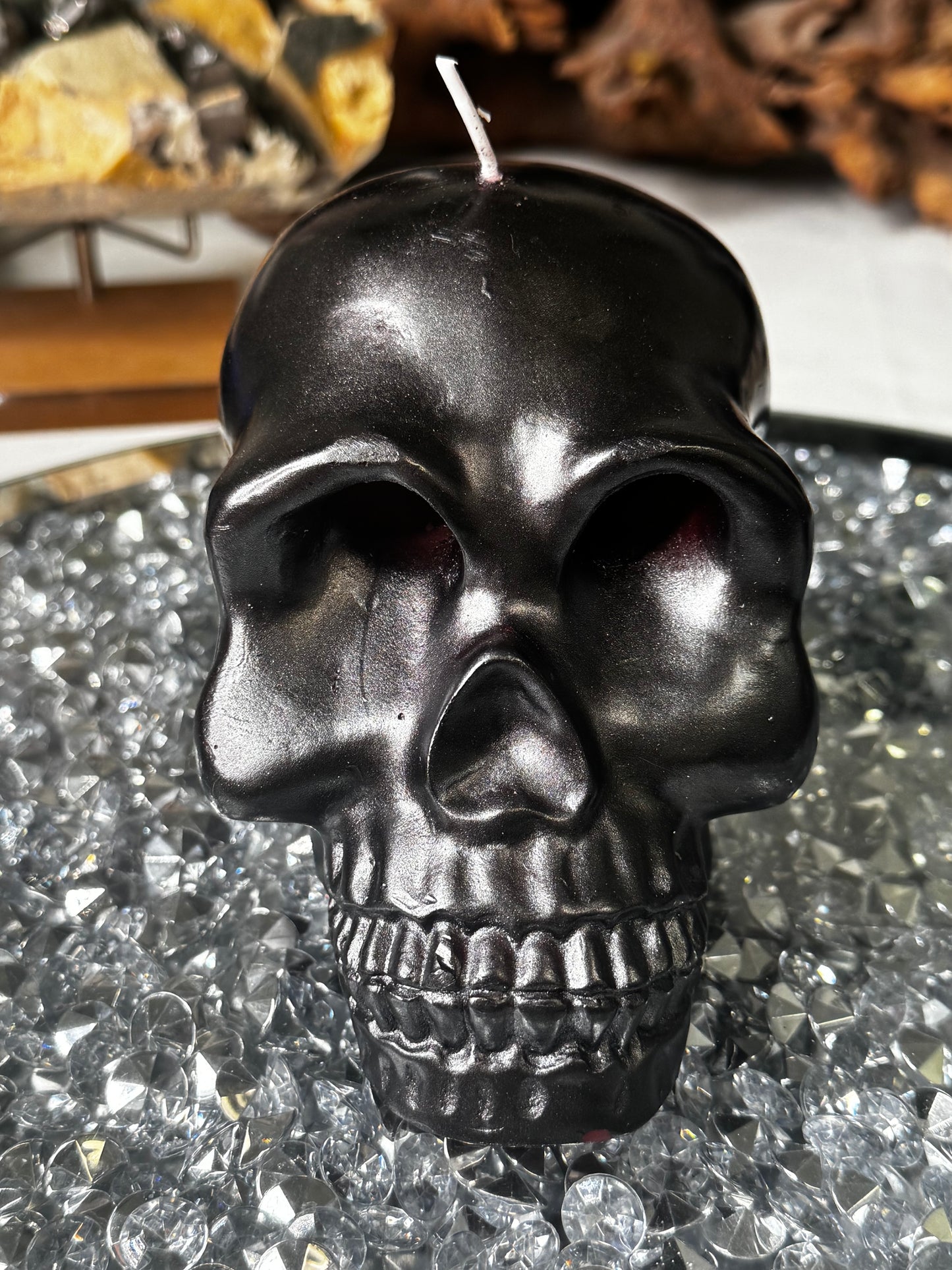 Black skull candle with red bleeding eyes