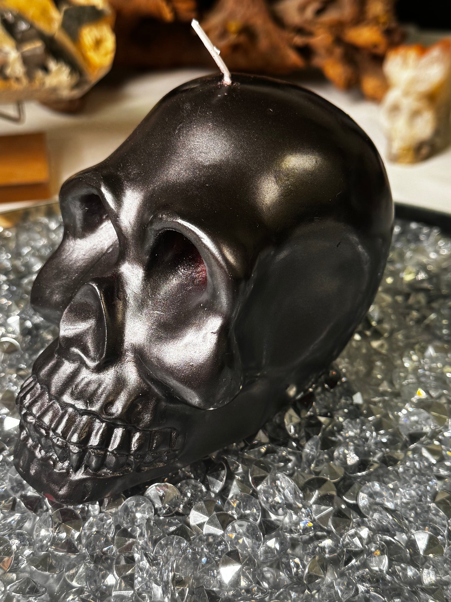 Black skull candle with red bleeding eyes